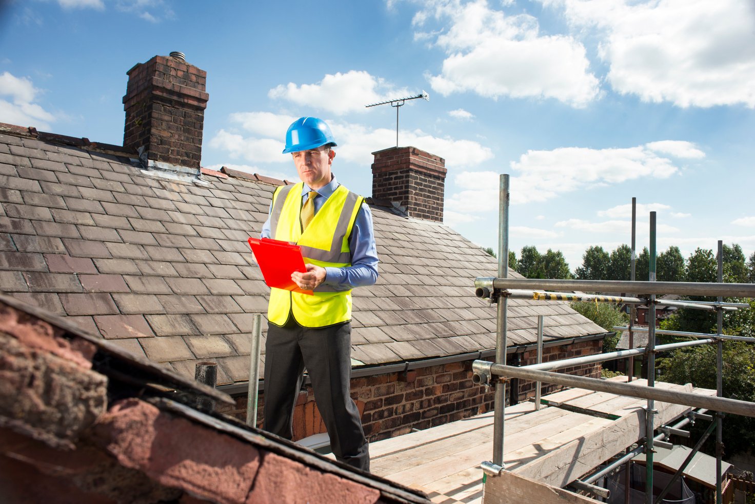 building inspector assesses slate roof condition